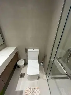 a small bathroom with a toilet and a shower at Lovely Studio, Azizi Riviera in Dubai