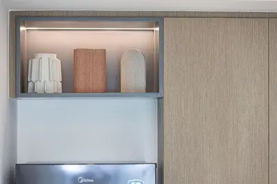 a shelf with towels and a microwave in a refrigerator at Luxury Minimalistic Apartment in Downtown Dubai Opposite Burj Khalifa & Dubai Mall in Dubai