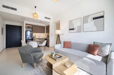 a living room with a couch and a table at Luxury Minimalistic Apartment in Downtown Dubai Opposite Burj Khalifa & Dubai Mall in Dubai