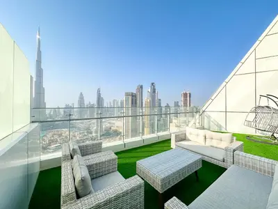 a balcony with couches and a view of the city at Panoramic Burj Khalifa View Luxury 1BR Penthouse in Dubai