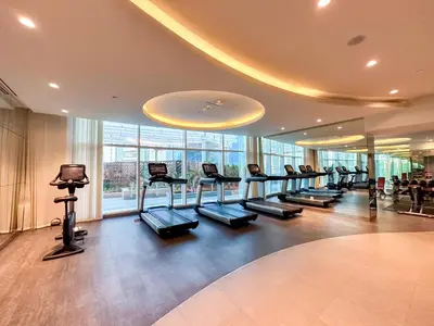 a gym with a row of treadmills in a building at Panoramic Burj Khalifa View Luxury 1BR Penthouse in Dubai