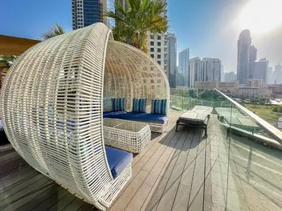 a wicker swing sitting on top of a balcony at Panoramic Burj Khalifa View Luxury 1BR Penthouse in Dubai
