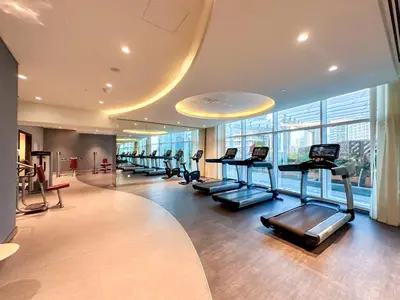 a gym with treadmills and ellipticals in a building at Panoramic Burj Khalifa View Luxury 1BR Penthouse in Dubai