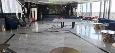 a lobby with a ping pong table and chairs at Bayz by Danube Marasi Drive in Dubai