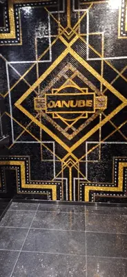 a black and yellow wall with a sign on it at Bayz by Danube Marasi Drive in Dubai