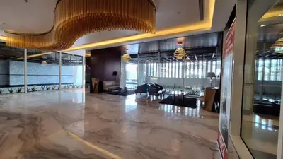 a lobby with a large marble floor and a chandelier at Bayz by Danube Marasi Drive in Dubai