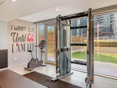 a fitness room with a gym with a treadmill at Stunning Canal Views l Sleeps 6 in Dubai
