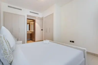 a white bedroom with a large white bed at STAY BY LATINEM Luxury 2BR Holiday Home CVR B1705 near Burj Khalifa in Dubai