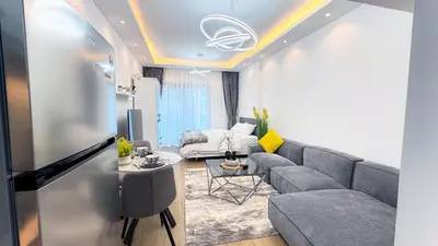 a living room with a couch and a table at Dubai Marina - Modern Classic Studio Apartment in Dubai