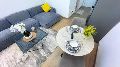 an overhead view of a living room with a couch and a table at Dubai Marina - Modern Classic Studio Apartment in Dubai