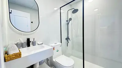 a bathroom with a toilet and a sink and a mirror at Dubai Marina - Modern Classic Studio Apartment in Dubai
