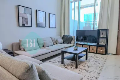 a living room with a couch and a tv at Bloomfields Cozy 1br Townhouse Life Style City in Nadd Shubayḩ