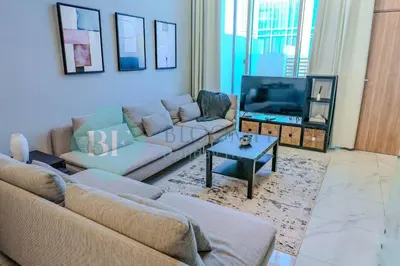 a living room with two couches and a tv at Bloomfields Cozy 1br Townhouse Life Style City in Nadd Shubayḩ