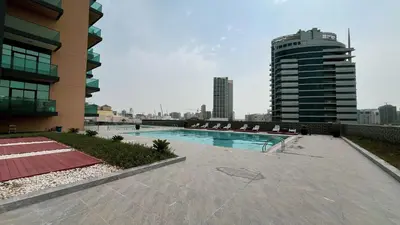 a swimming pool on the roof of a building at LUXE | Studio in JVC | Cozy and Stylish in Dubai