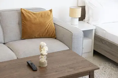 a living room with a couch and a coffee table at LUXE | Studio in JVC | Cozy and Stylish in Dubai