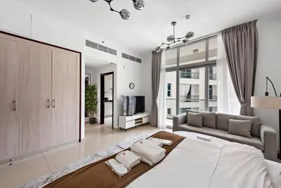 a large bedroom with a large bed and a couch at Studio -DEC Towers T2 - Near Marina Beach in Dubai