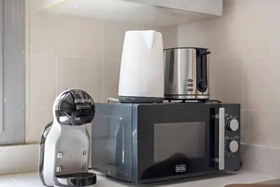 a kitchen counter with a toaster and a microwave at Studio -DEC Towers T2 - Near Marina Beach in Dubai
