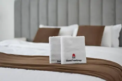 a white towel sitting on top of a bed at Studio -DEC Towers T2 - Near Marina Beach in Dubai
