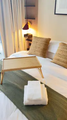 a hotel room with two beds and a coffee table at Stylish apartment in the center!10 minutes to Dubai mall and World Trade Center in Dubai