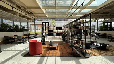 a library with bookshelves and a couch and tables at Stylish apartment in the center!10 minutes to Dubai mall and World Trade Center in Dubai