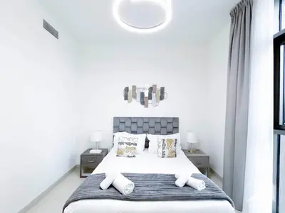a white bedroom with a bed with two pillows at Stunning Burj Crown 2Bedroom with Balcony & view in Dubai
