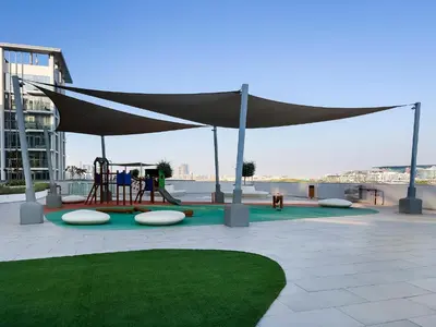 a playground with a canopy and a play equipment at Spacious 1 BR Lagoon in Dubai