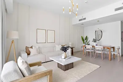 a living room with a white couch and a table at Silkhaus Heart of Downtown 3 BDR with Maid Room in Dubai