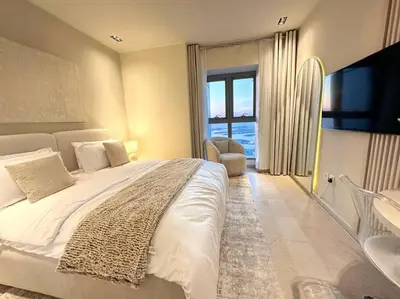 a bedroom with a large bed and a large window at Breathtaking 2BR with Full SeaView in Dubai