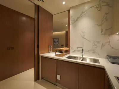 a kitchen with a sink and a map on the wall at Venetian - The Address Residences Dubai Opera Full Burj & Fountain Views in Dubai