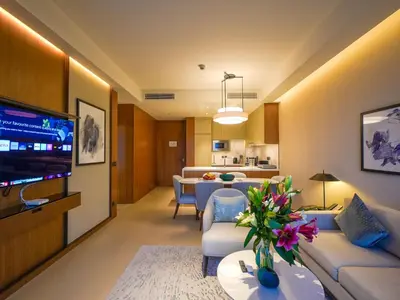 a living room with a couch and a dining room at Venetian - The Address Residences Dubai Opera Full Burj & Fountain Views in Dubai