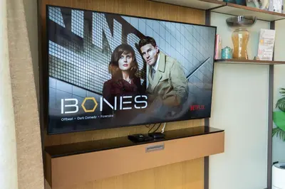 a flat screen tv on a wall with a movie on it at Luxury Suite at Address Residences Dubai Opera , High-Floor Ocean Views, Burj Khalifa Pool Access, Steps from Dubai Mall in Dubai