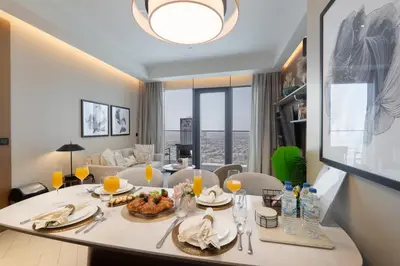 a dining room with a table with food on it at Luxury Suite at Address Residences Dubai Opera , High-Floor Ocean Views, Burj Khalifa Pool Access, Steps from Dubai Mall in Dubai