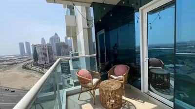a balcony with chairs and a view of the city at Venetian - Stay in Business Bay near Burj Khalifa views in Dubai