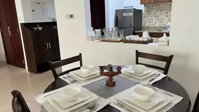 a dining room with a table and a kitchen at Venetian - Stay in Business Bay near Burj Khalifa views in Dubai