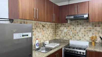 a kitchen with a stainless steel refrigerator and a sink at Venetian - Stay in Business Bay near Burj Khalifa views in Dubai