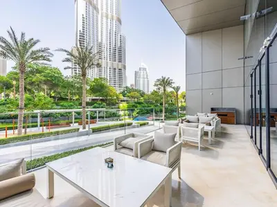 a view of a building with tables and chairs at Luxury 3BR Apartment at Address Opera in Dubai