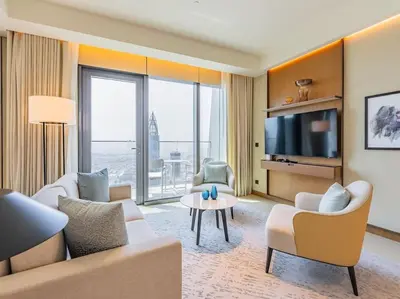 a living room with a couch and a tv at Luxury 3BR Apartment at Address Opera in Dubai