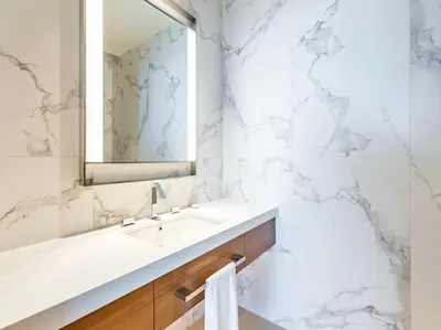 a white bathroom with a sink and a mirror at Luxury 3BR Apartment at Address Opera in Dubai