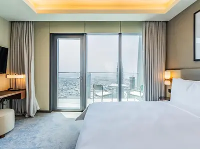 a hotel room with a bed and a large window at Luxury 3BR Apartment at Address Opera in Dubai