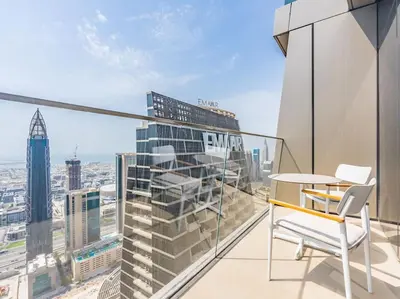 a balcony with a table and chair on a building at Luxury 3BR Apartment at Address Opera in Dubai