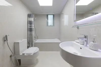 a bathroom with a sink and a toilet and a tub at Stylish 2 bd Apt in Business Bay, Prime Location in Dubai