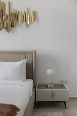 a bedroom with a bed and a side table at Stylish 2 bd Apt in Business Bay, Prime Location in Dubai