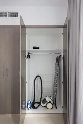 a glass cabinet with a vacuum and a hose at Stylish 2 bd Apt in Business Bay, Prime Location in Dubai