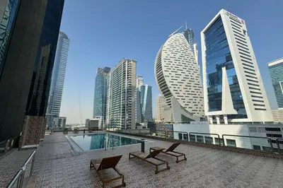 a pool in the middle of a city with tall buildings at Stylish 2 bd Apt in Business Bay, Prime Location in Dubai