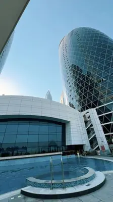 a large building with a pool in front of it at DIFC Luxury 1-Bed Apt with Stunning City Views in Dubai