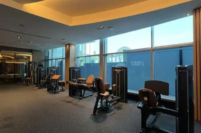 a gym with a row of chairs and windows at DIFC Luxury 1-Bed Apt with Stunning City Views in Dubai
