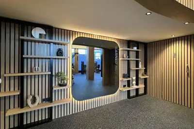 a hallway with a mirror in a room with wooden walls at DIFC Luxury 1-Bed Apt with Stunning City Views in Dubai