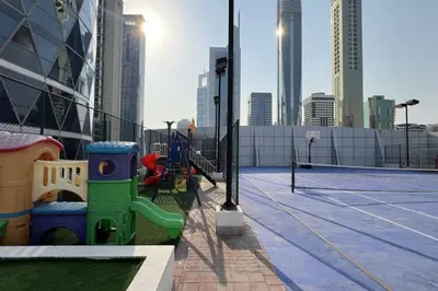 a playground on a building with a tennis court at DIFC Luxury 1-Bed Apt with Stunning City Views in Dubai
