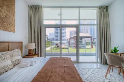 a bedroom with a large bed and a large window at ShoresInn - Outdoor Retreat with Private Terrace in Dubai