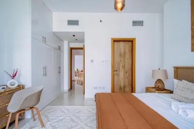 a bedroom with a bed and a desk and a chair at ShoresInn - Outdoor Retreat with Private Terrace in Dubai